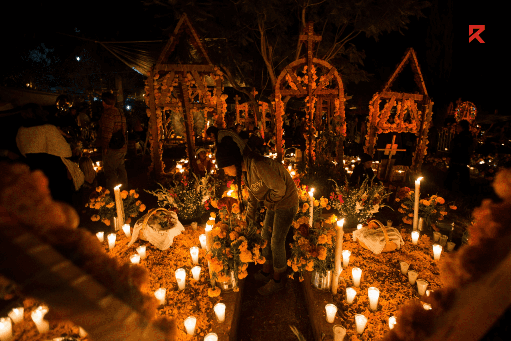 This is Mexico cemetery decorated with yellow flowers and candles on Halloween.