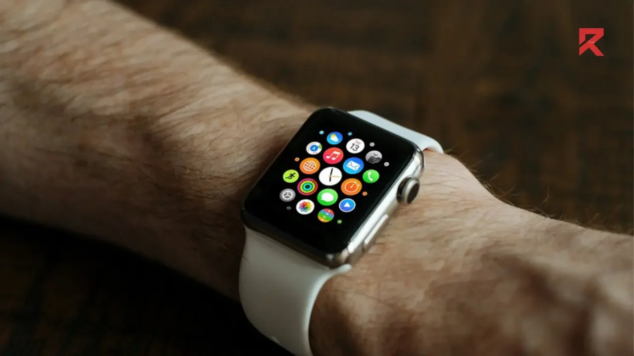 A arm of a man with apple watch on it
